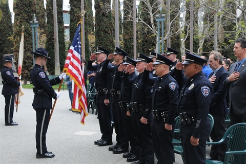 Officers and Community Members Salute the American Flag 