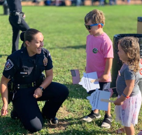A special enforcement team member with kids at Fiesta La Ballona.